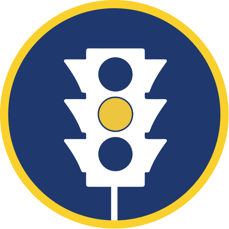 A 3-light traffic signal with only the yellow light lit