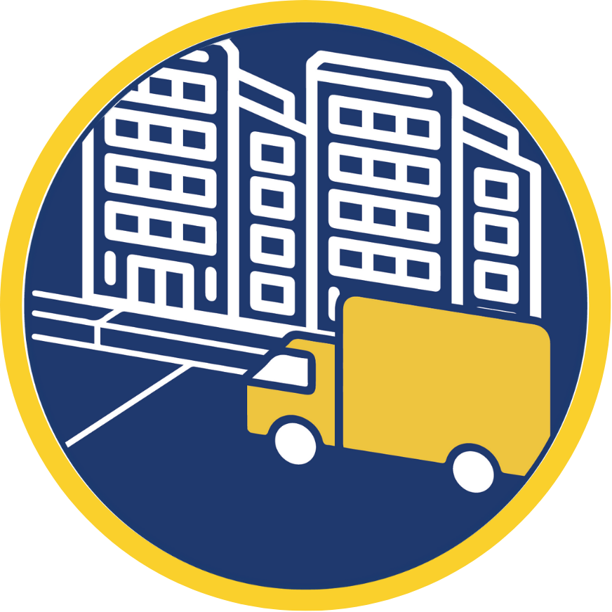 A box truck parked along a curb in front of two five-story buildings