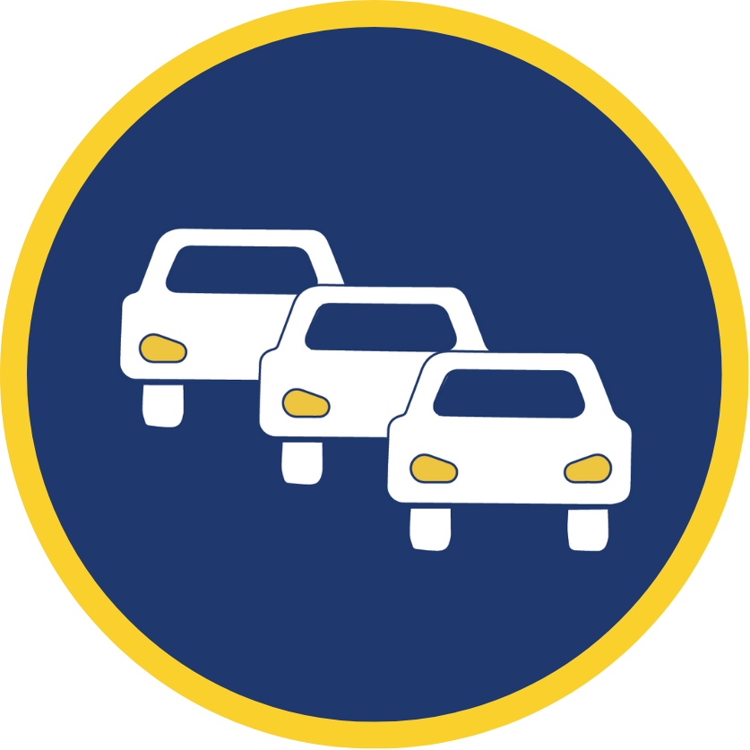 Three white cars driving forward in a queue with their headlights on